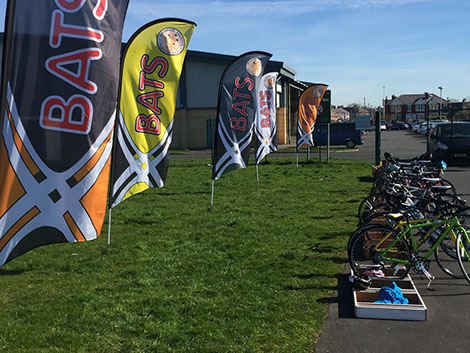 Photograph of Blackpool Aquatics Triathlon team flags, next to the bikes at the rear of Palatine Leisure Centre, Blackpool.